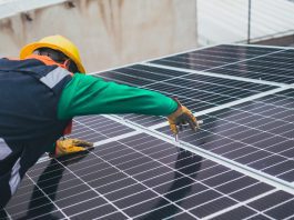 A solar technician installing a solar panel